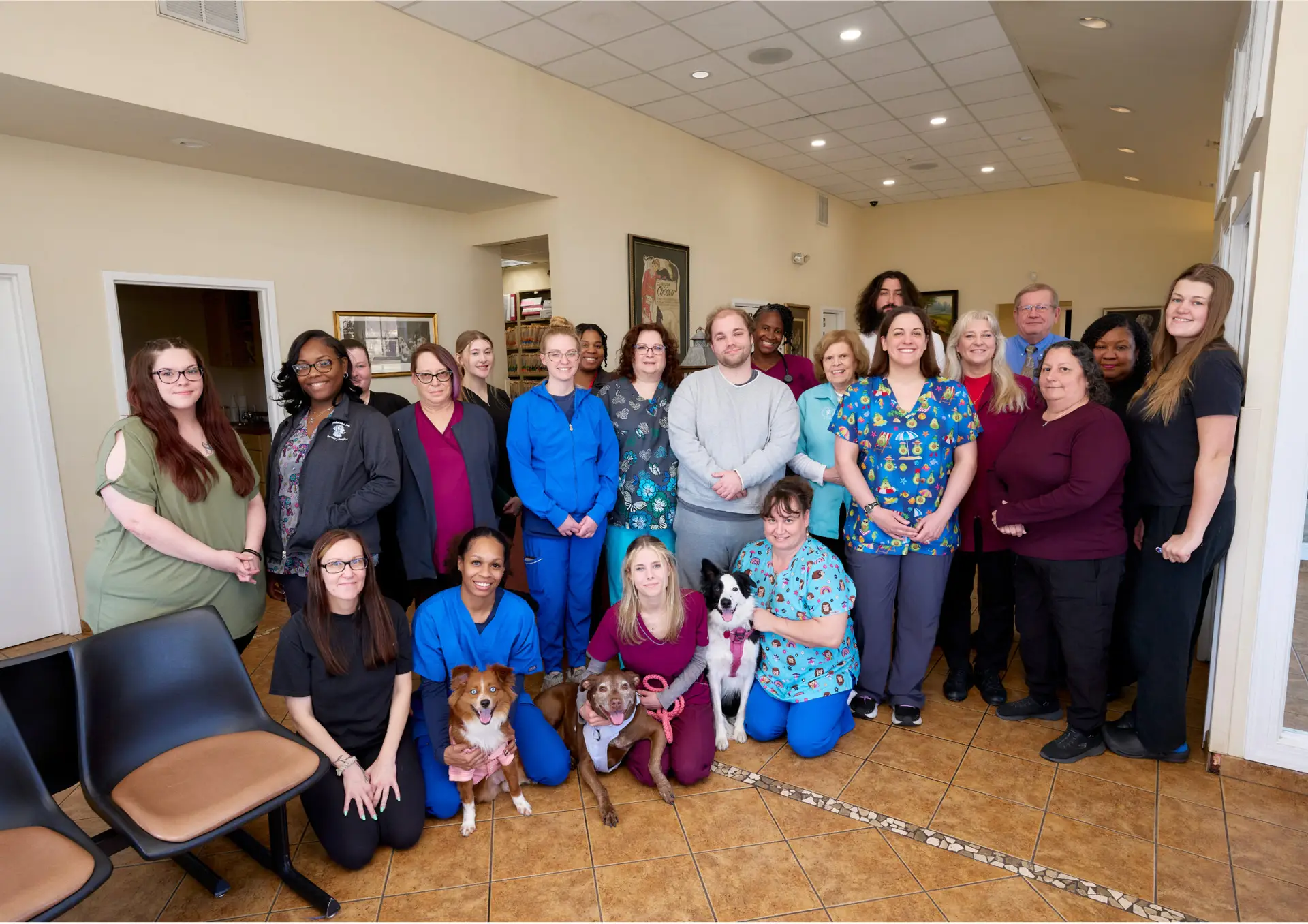 The team at Armistead Avenue Veterinary Hospital posing for a group photo inside lobby of their animal hospital